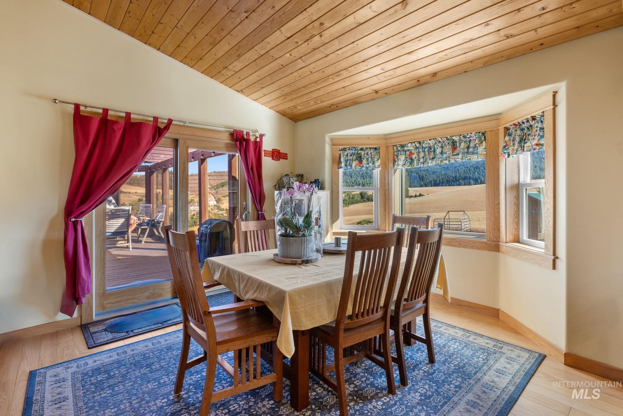 1199 Walker Road Viola, ID 83872 - Photo 9 of 50 Dining area featuring vaulted ceiling, plenty of natural light, wood ceiling, and wood finished floors