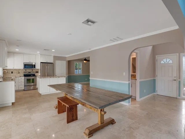 an empty room with wooden floor chandelier fan and closet area