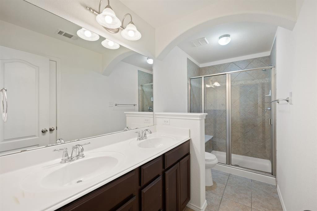 1013 Lucy Lane Allen, TX 75013 - Photo 12 of 30 a bathroom with a double vanity sink mirror and shower