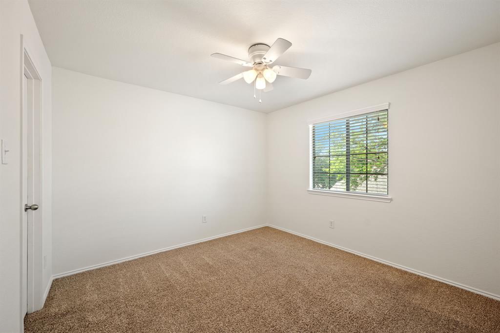 1013 Lucy Lane Allen, TX 75013 - Photo 20 of 30 an empty room with windows and fan