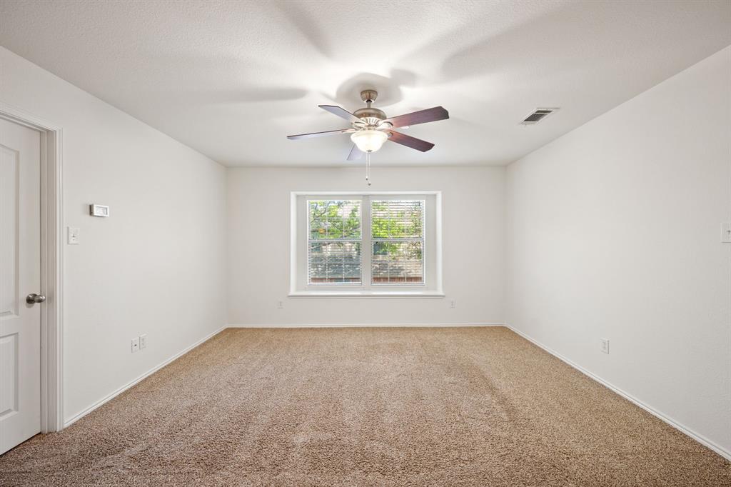 1013 Lucy Lane Allen, TX 75013 - Photo 21 of 30 an empty room with a window and a fan