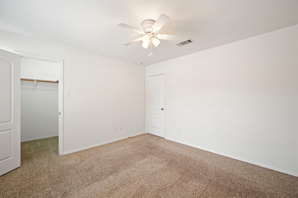 1013 Lucy Lane Allen, TX 75013 - Photo 22 of 30 a view of an empty room with a chandelier fan
