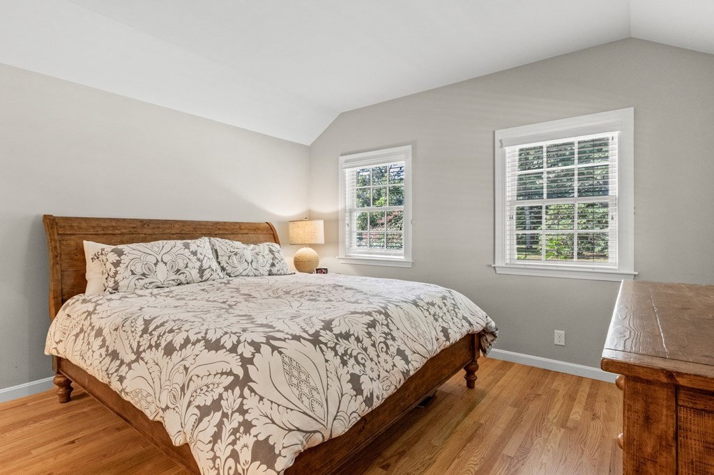 218 Scudder Road Barnstable, MA 02655 - Photo 17 of 36 a bedroom with a bed and wooden floor