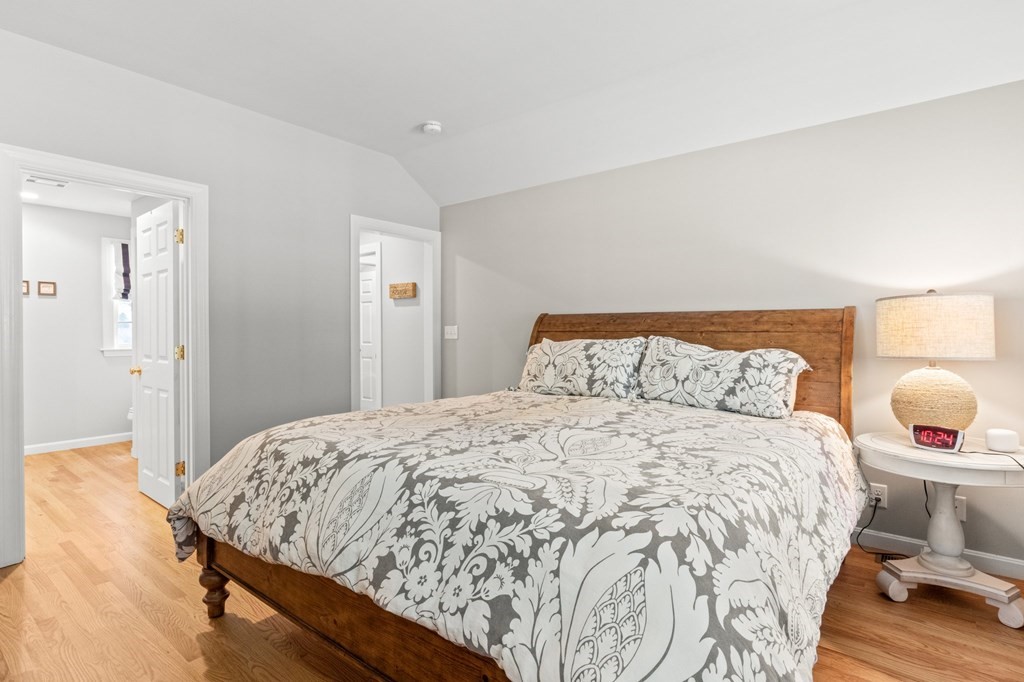 218 Scudder Road Barnstable, MA 02655 - Photo 18 of 36 a bedroom with a bed and wooden floor