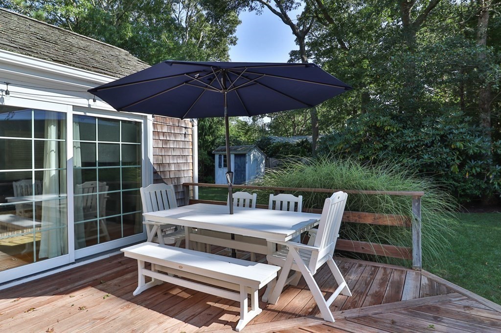 218 Scudder Road Barnstable, MA 02655 - Photo 30 of 36 a patio with a patio table and chairs