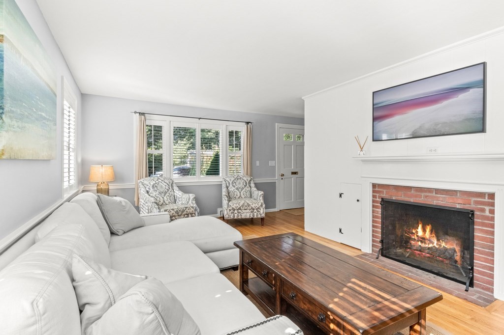 218 Scudder Road Barnstable, MA 02655 - Photo 3 of 36 a living room with furniture a fireplace and a large window