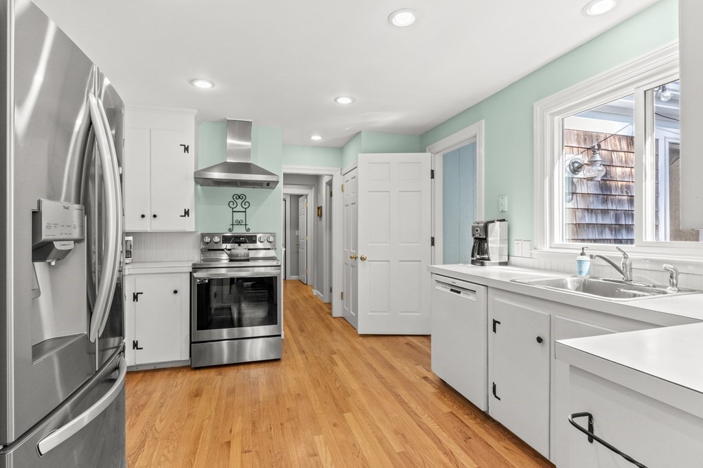 218 Scudder Road Barnstable, MA 02655 - Photo 5 of 36 a kitchen with stainless steel appliances sink stove refrigerator and cabinets
