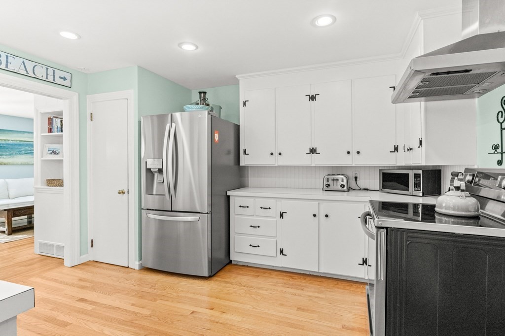 218 Scudder Road Barnstable, MA 02655 - Photo 7 of 36 a kitchen with stainless steel appliances a refrigerator sink and cabinets