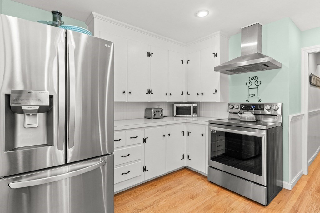 218 Scudder Road Barnstable, MA 02655 - Photo 9 of 36 a kitchen with stainless steel appliances granite countertop a stove a refrigerator and a stove top oven