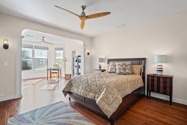 a bedroom with a bed and wooden floor