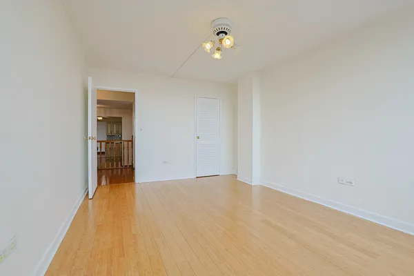 a view of a livingroom with wooden floor and a ceiling fan