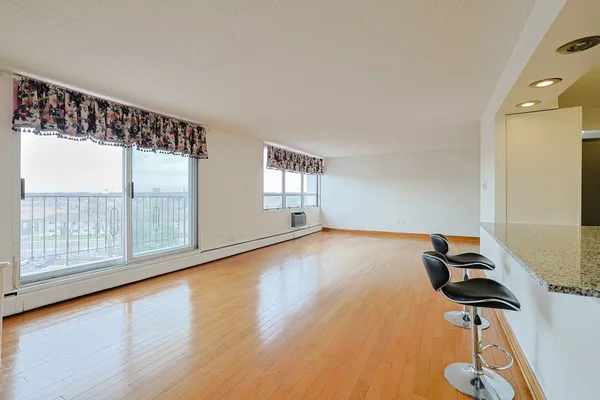 a view of room with window and wooden floor