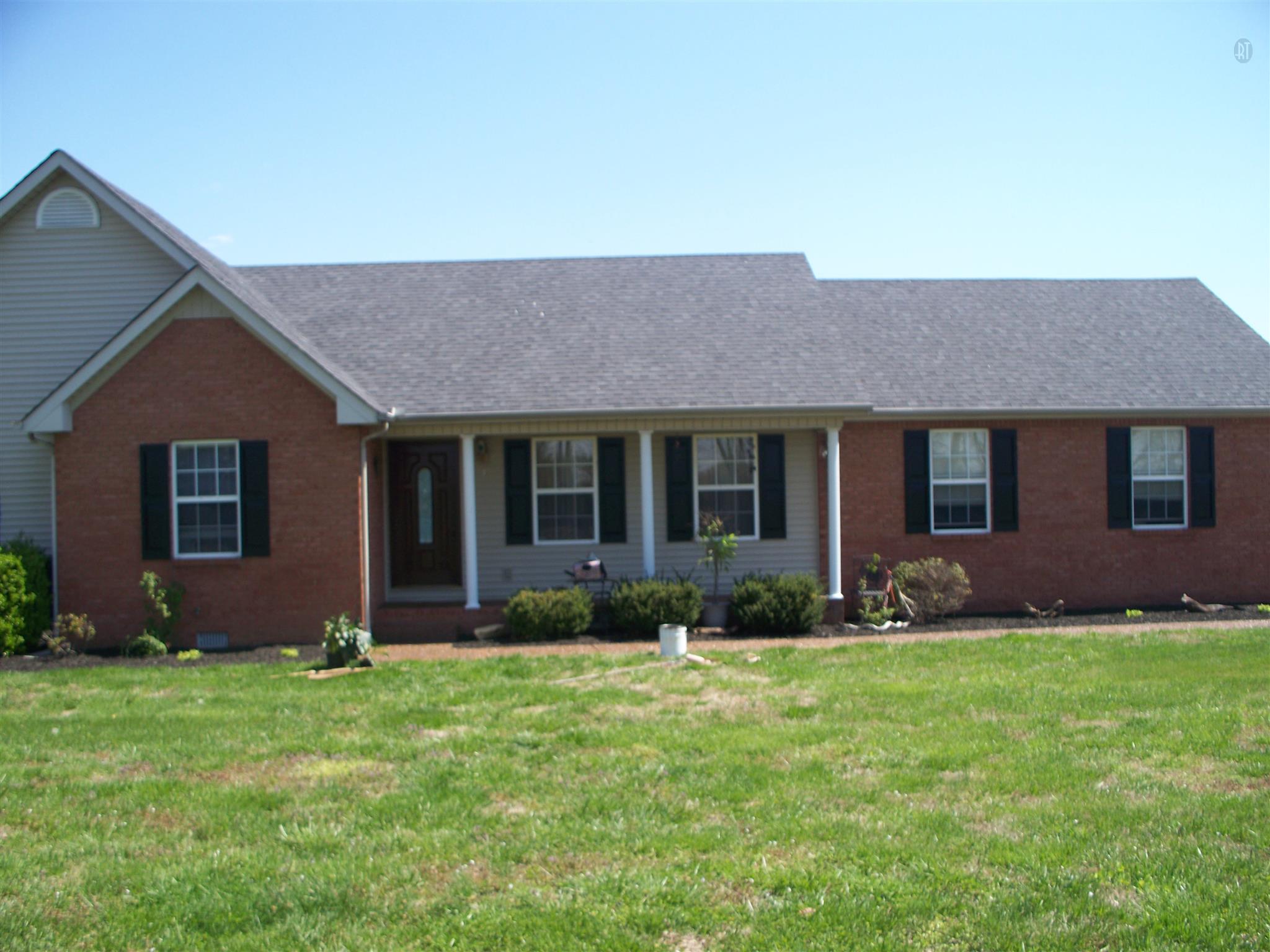 166 Cook Road Portland, TN 37148 - Photo 7 of 11 a front view of a house with a garden and plants