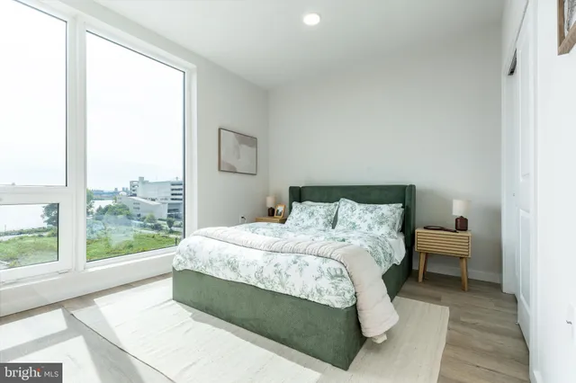 a large bed sitting in a bedroom next to a window