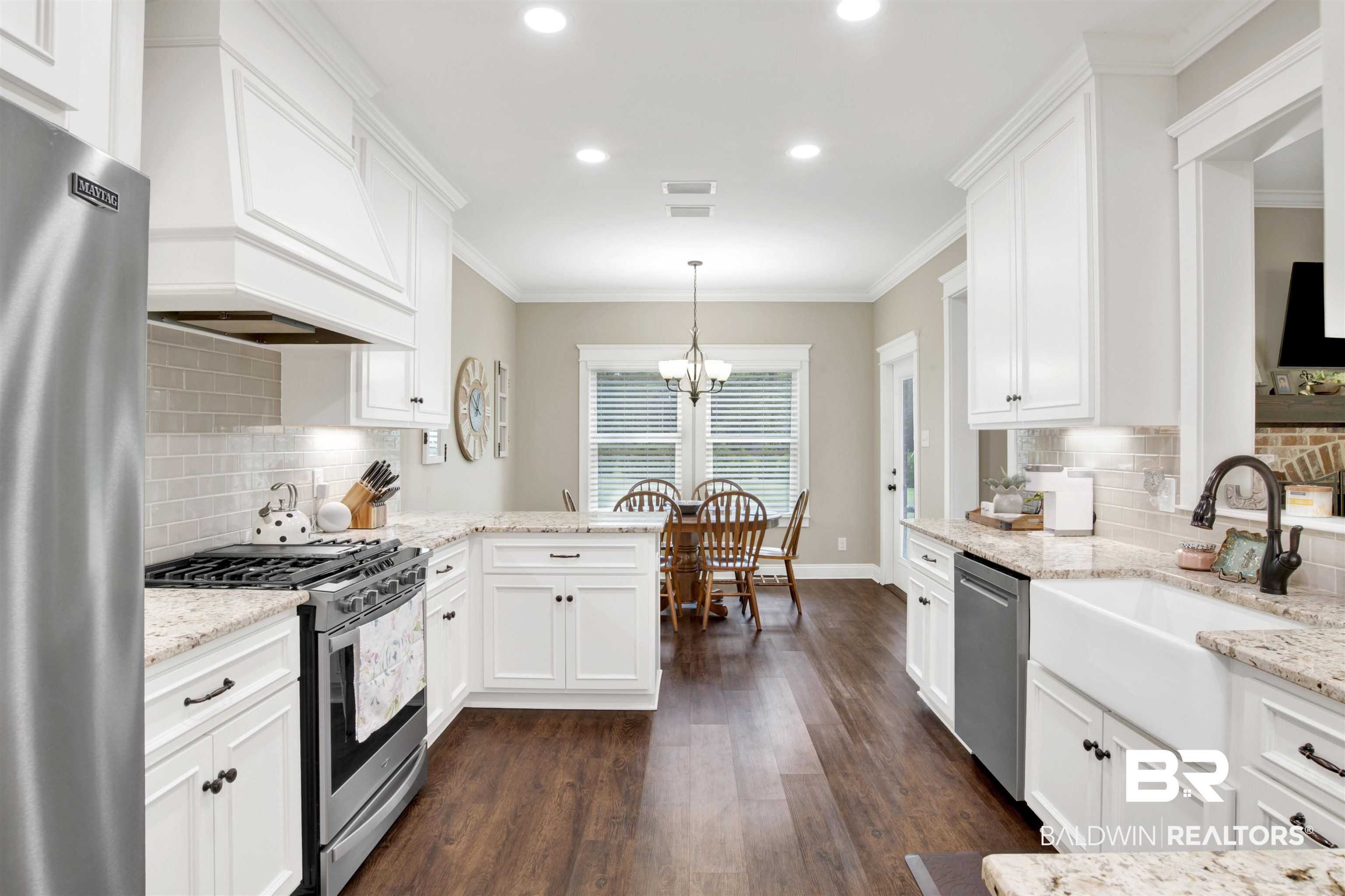 2440 Johnson Road West Mobile, AL 36695 - Photo 18 of 40 Kitchen with custom range hood, stainless steel appliances, dark wood-type flooring, pendant lighting, and white cabinets