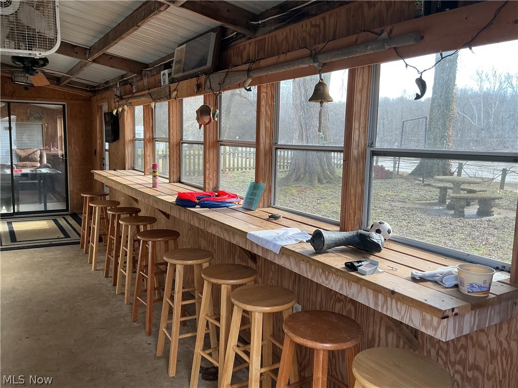 9385 North River Road East, Unit 33 Dresden, OH 43821 - Photo 16 of 19 Indoor dry bar featuring wood counters, concrete flooring, and wood walls