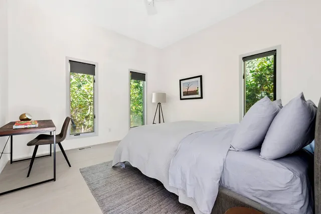 a bed room with a bed and a chair