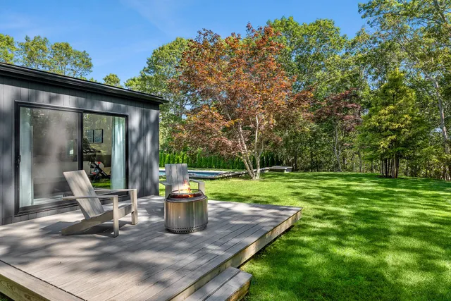 a view of a house with backyard and sitting area