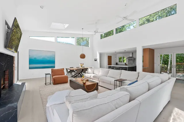 a living room with furniture fireplace and a flat screen tv
