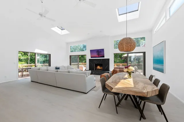 a living room with furniture a fireplace and a table