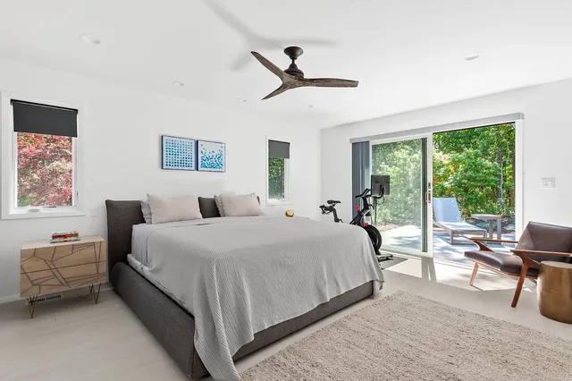 a bedroom with a bed and a large window