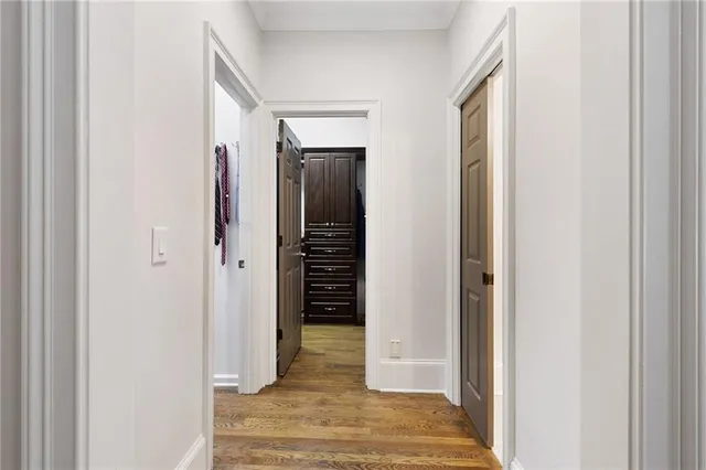 a view of a hallway with wooden floor and entryway