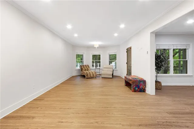 a big room with wooden floor and furniture