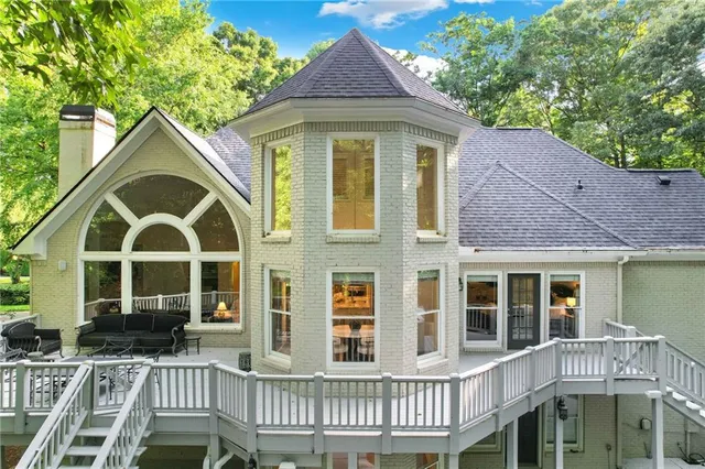 a view of a brick house with a windows and wooden fence
