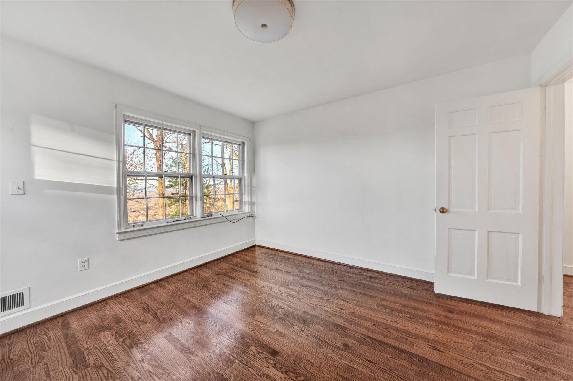 3442 West Ridge Road Southwest Roanoke, VA 24014 - Photo 22 of 42 a view of an empty room with wooden floor and a window