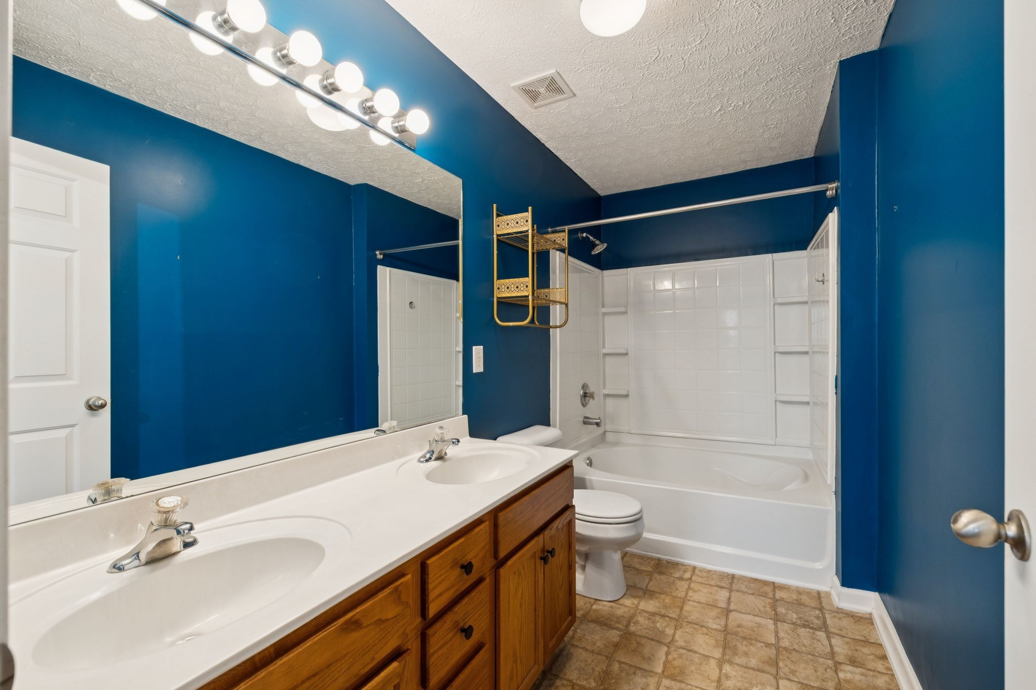 1345 Bell Road, Unit 412 Antioch, TN 37013 - Photo 20 of 33 a bathroom with a double vanity sink a toilet and shower