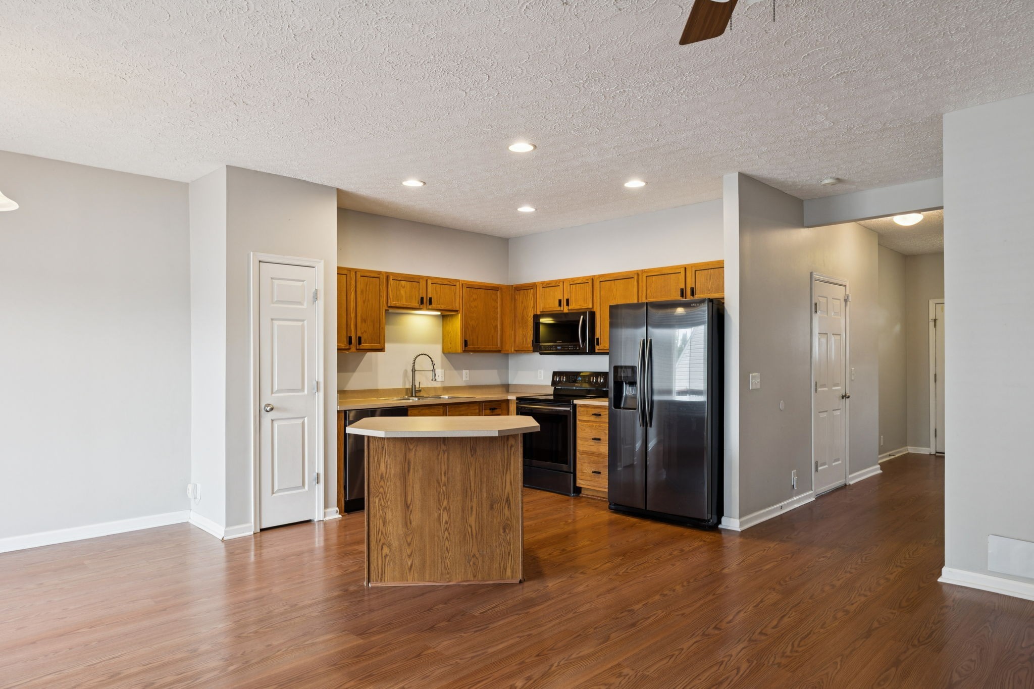 1345 Bell Road, Unit 412 Antioch, TN 37013 - Photo 10 of 33 a kitchen with stainless steel appliances granite countertop a refrigerator a sink a stove and oven with wooden floor