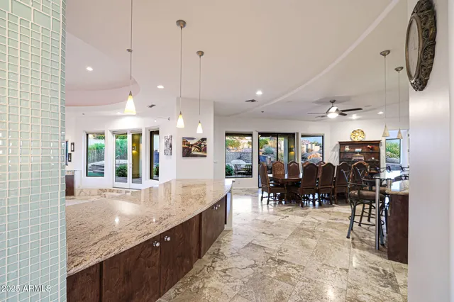 a bathroom with a granite countertop toilet sink and mirror