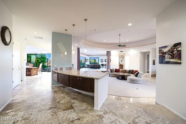 a living room with furniture a rug and a large window