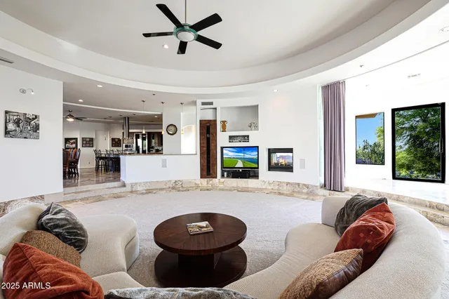 a living room with furniture and a floor to ceiling window