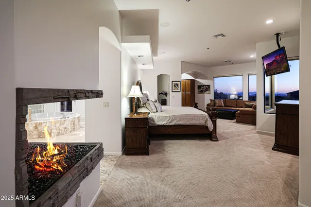 a bedroom with a bed and a painting on the wall