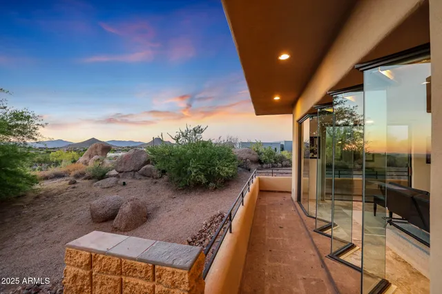 a view of a patio with table and chairs potted plants with wooden floor and fence