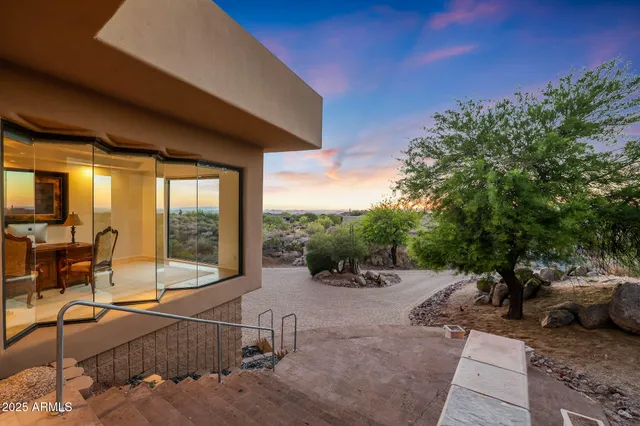 a view of a backyard with table and chairs under an umbrella