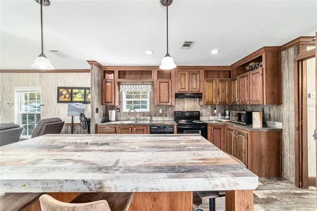 a kitchen with stainless steel appliances a sink stove and cabinets