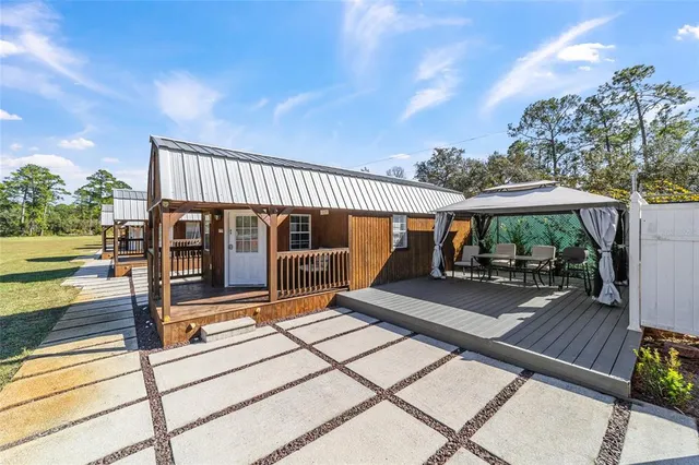 a dining room with furniture and a wooden floor