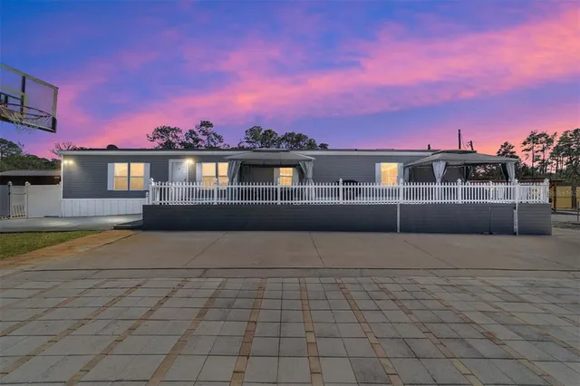 a large kitchen with kitchen island a large counter top space a sink stainless steel appliances and cabinets