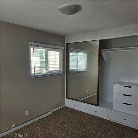 an empty room with windows and closet