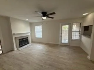 a view of a livingroom with a fireplace and window
