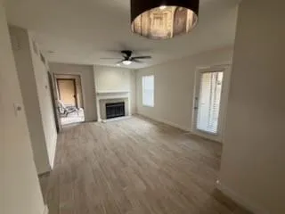 an empty room with windows and fireplace