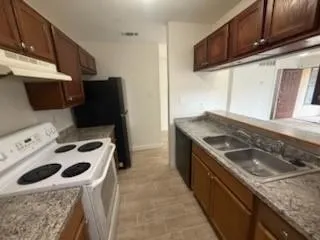 a kitchen with a stove and a sink