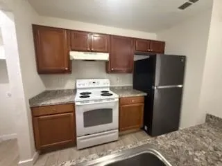 a kitchen with a stove and a refrigerator