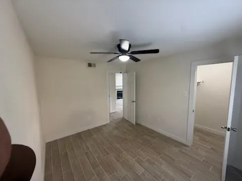 a view of an empty room and wooden floor