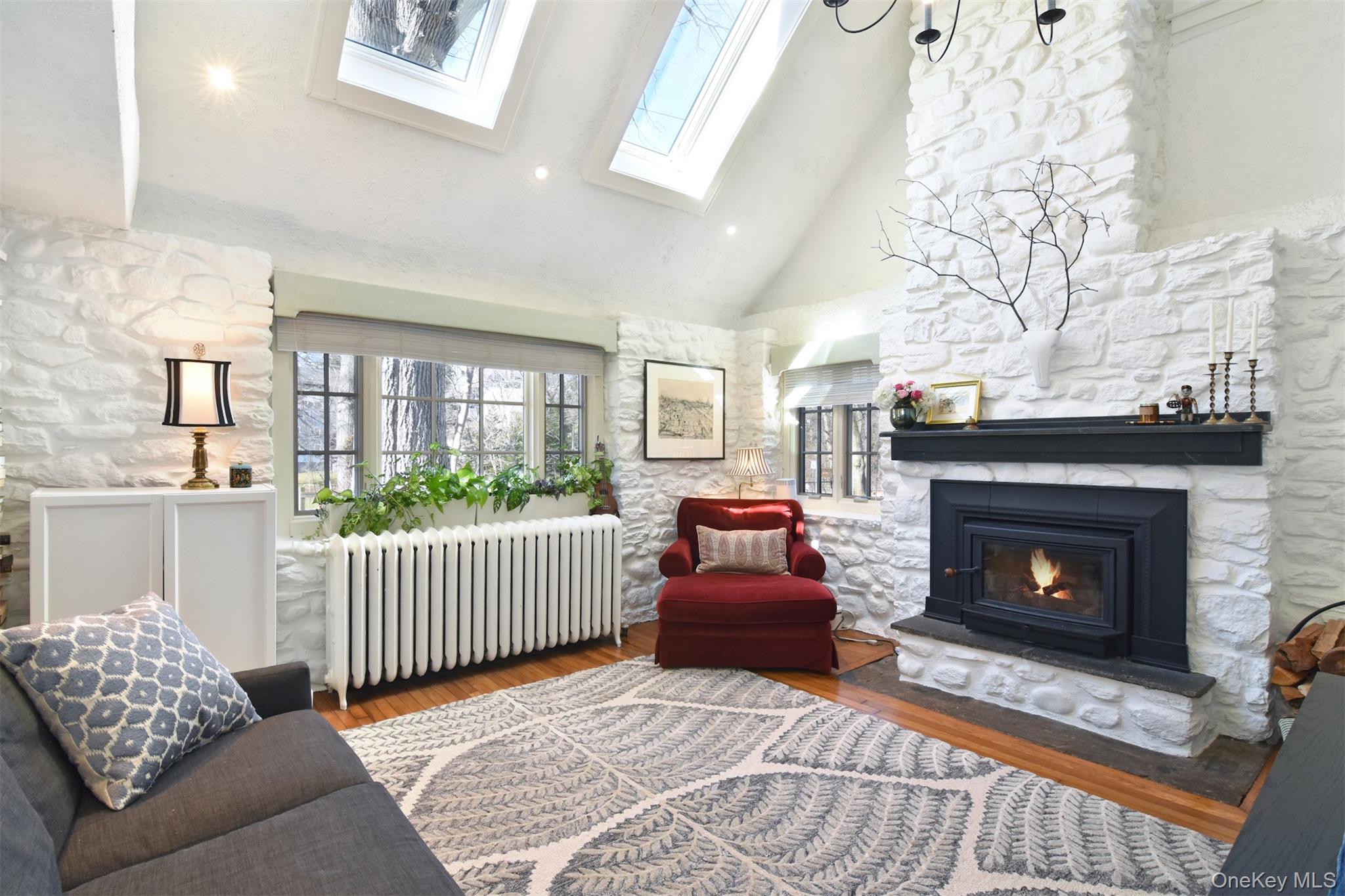 116 Potter Road Scarsdale, NY 10583 - Photo 5 of 38 Stunning living room with vaulted ceiling, skylights and unique stone fireplace.