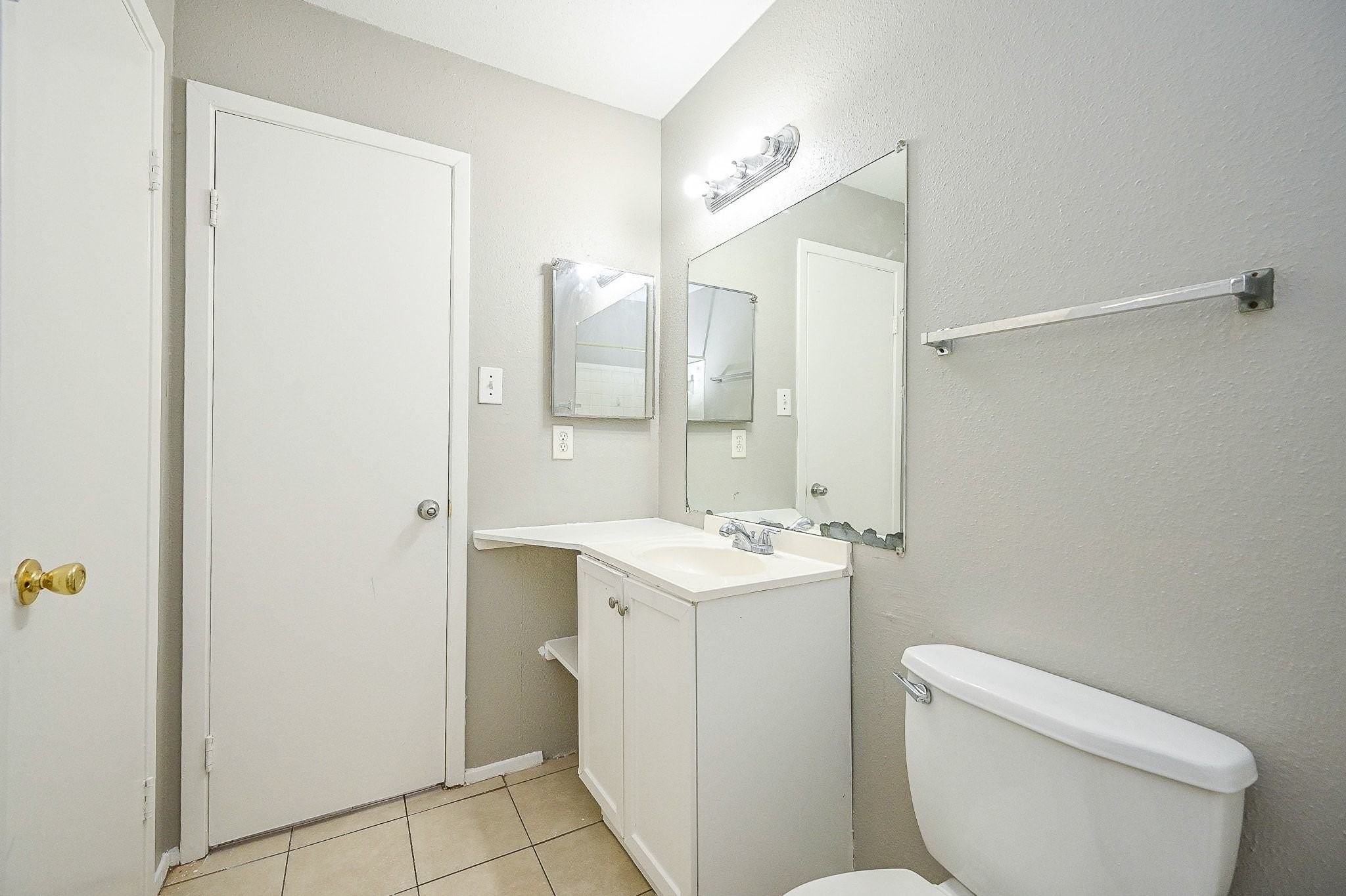 16303 Lyons School Road, Unit 703 Spring, TX 77379 - Photo 13 of 19 a bathroom with a toilet sink and mirror