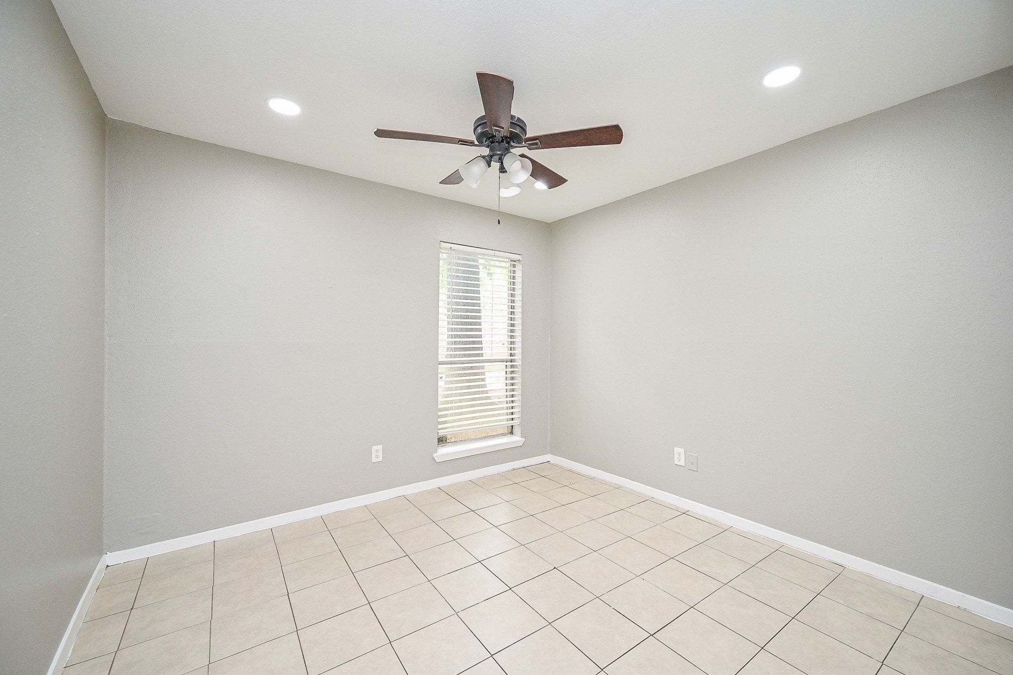 16303 Lyons School Road, Unit 703 Spring, TX 77379 - Photo 14 of 19 an empty room with windows and fan