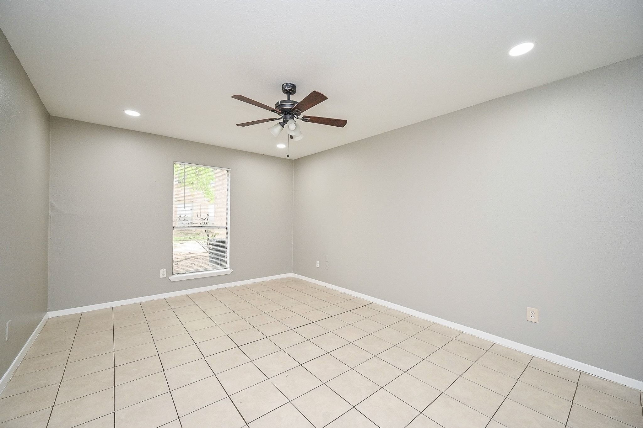 16303 Lyons School Road, Unit 703 Spring, TX 77379 - Photo 9 of 19 an empty room with windows and fan